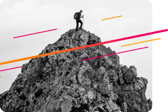 A solo backpacker at the top of a rocky outcrop.